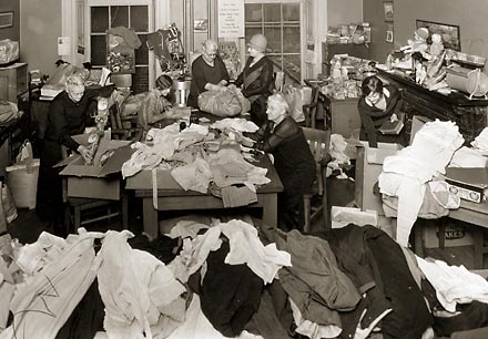 The Inner Mission Society Auxiliary prepares clothing for the needy.